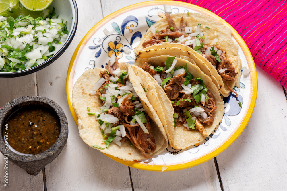 Mexican slow cooked lamb tacos also called barbacoa on white background