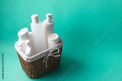 A basket full of white plastic cosmetic bottles on a blue background