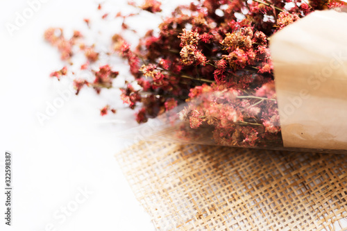 Soft focus pink dried flowers on white marble with copy space, Valentine day