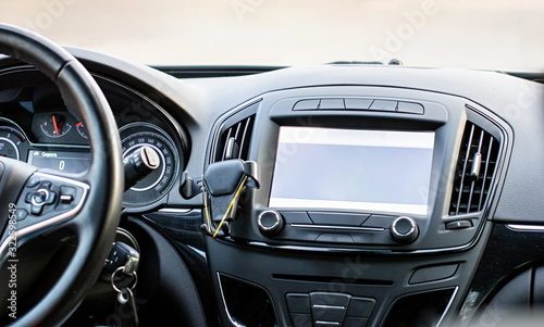 Car navigation system. GPS device in car help driver to find the way. Blank screen with place for text. © Elena
