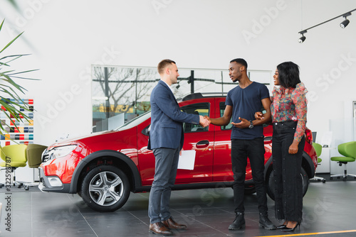 young african couple buying new car at dealership © Serhii