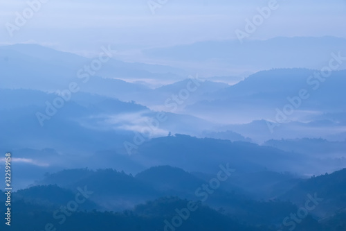 mountains valley with the sea of fog and clouds.Layers of mountains in morning sunrise. © MemoryMan