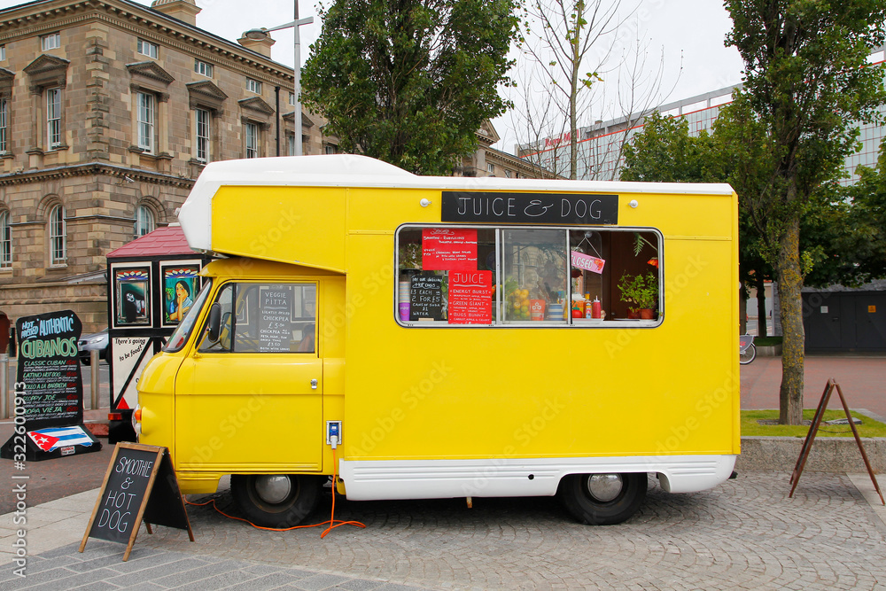 BELFAST, IRELAND AUGUST 08, 2015 Yellow food truck of natural fruit