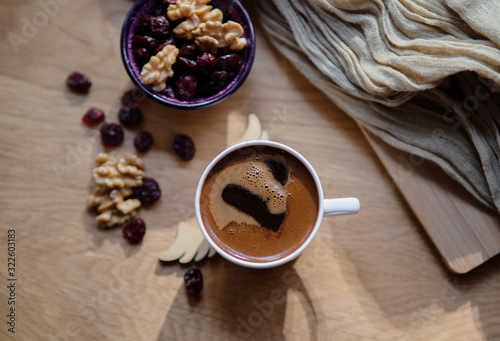 turkish coffee with dry berreis and walnut on wood table photo