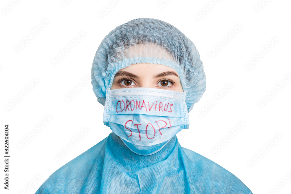 Portrait of sick woman wearing medical uniform and mask with stop coronavirus word isolated on white background. Coronavirus and health care concept Portrait of sick woman wearing medical uniform and mask with stop coronavirus word isolated on white background. Coronavirus and health care concept