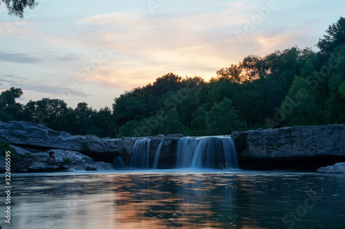 The sun sets over McKinney Falls, Texas. 