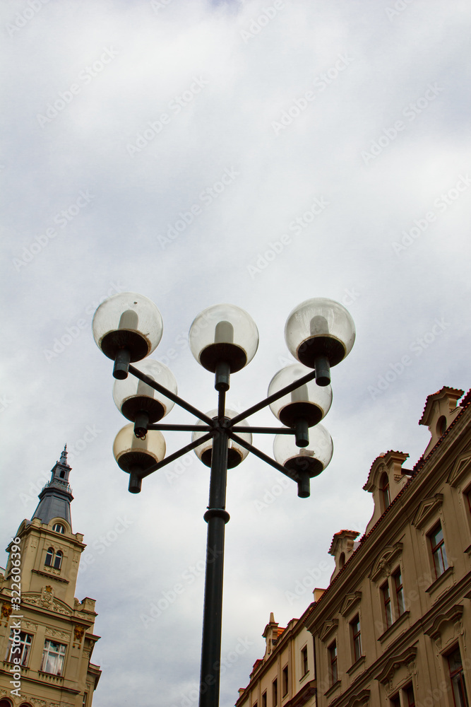 Prague. 05.10.2019: Prague street lamp. Wrought iron flashlight on the background of buildings on the wall.