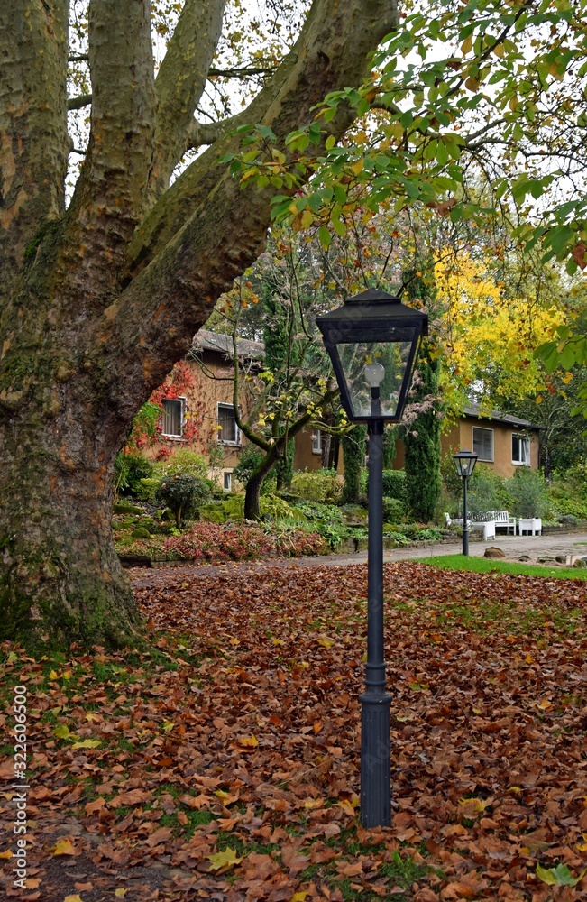 retro style street lantern in Autumn in a park setting, fall leaves on the ground, city park Stadtpark Lahr, Baden Ortenau Germany retro style street lantern in Autumn in a park setting, fall leaves on the ground, city park Stadtpark Lahr, Baden Ortenau Germany