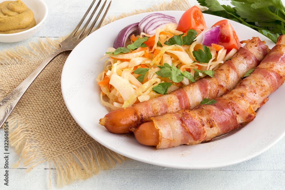fried sausages with bacon on a plate.