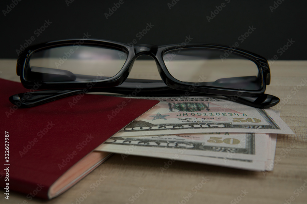 Money dollar, eye glasses and red passport. Travel and finance concept. Money dollar, eye glasses and red passport. Travel and finance concept.