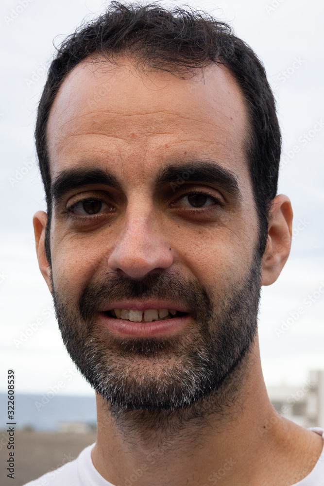 Bearded man portrait with receding hairline. Young male head shot. Shaving concept