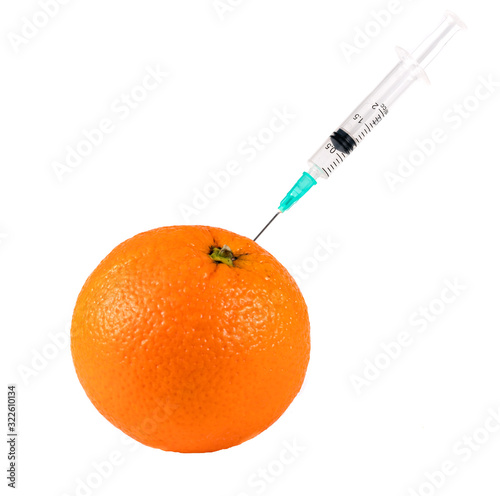 Orange On A White Background In Which Enter Gmo And Nitrates, Close-Up, Genetically Modified