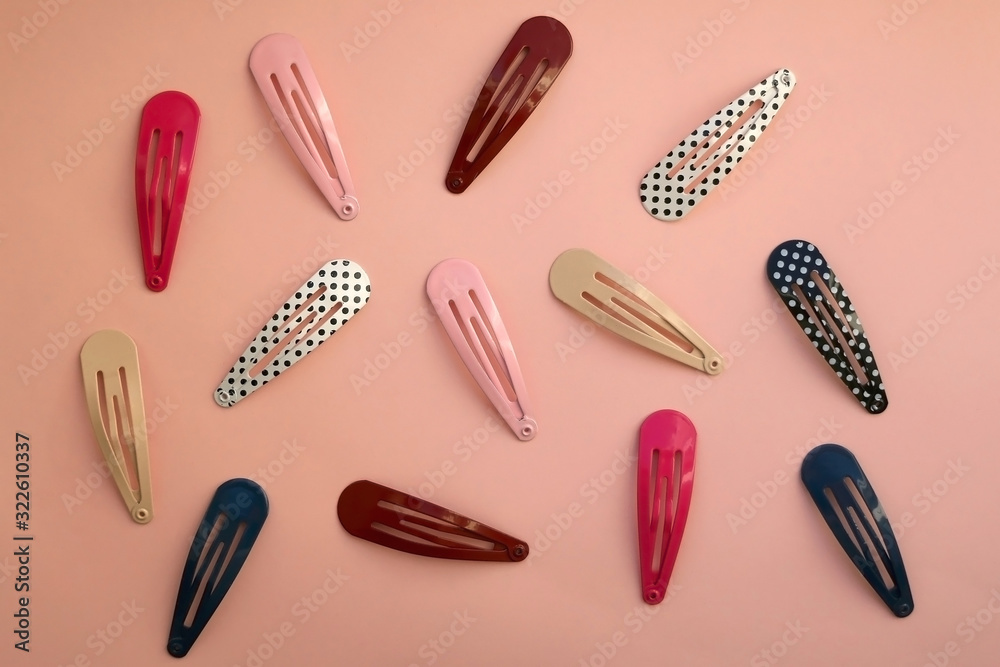 Colorful trendy hair clips on bright pink background. Top view. Colorful trendy hair clips on bright pink background. Top view.