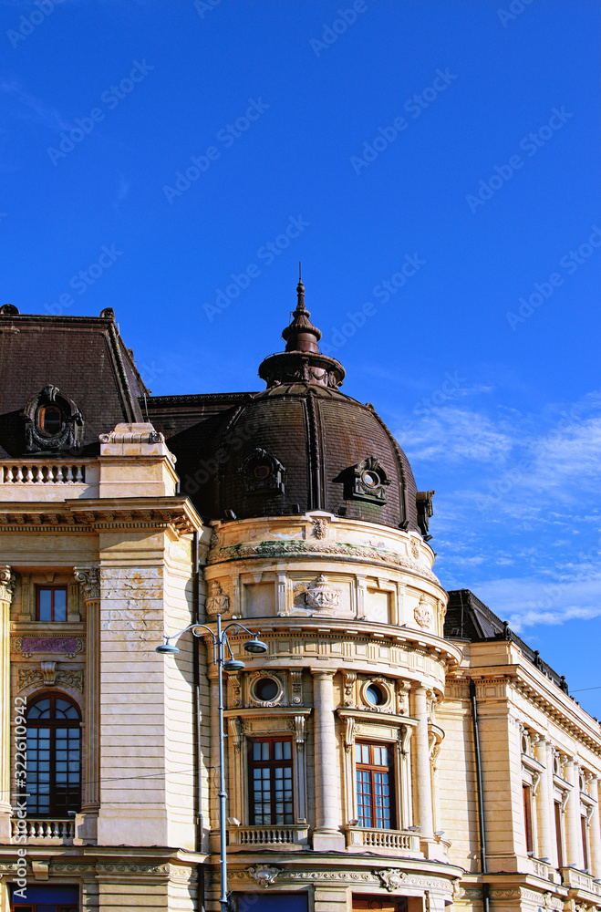 Ancient facade of the Central University Library against blue sky. It founded in 1895 as the Carol I Library of the University Foundation. Notable landmark of Bucharest, Romania