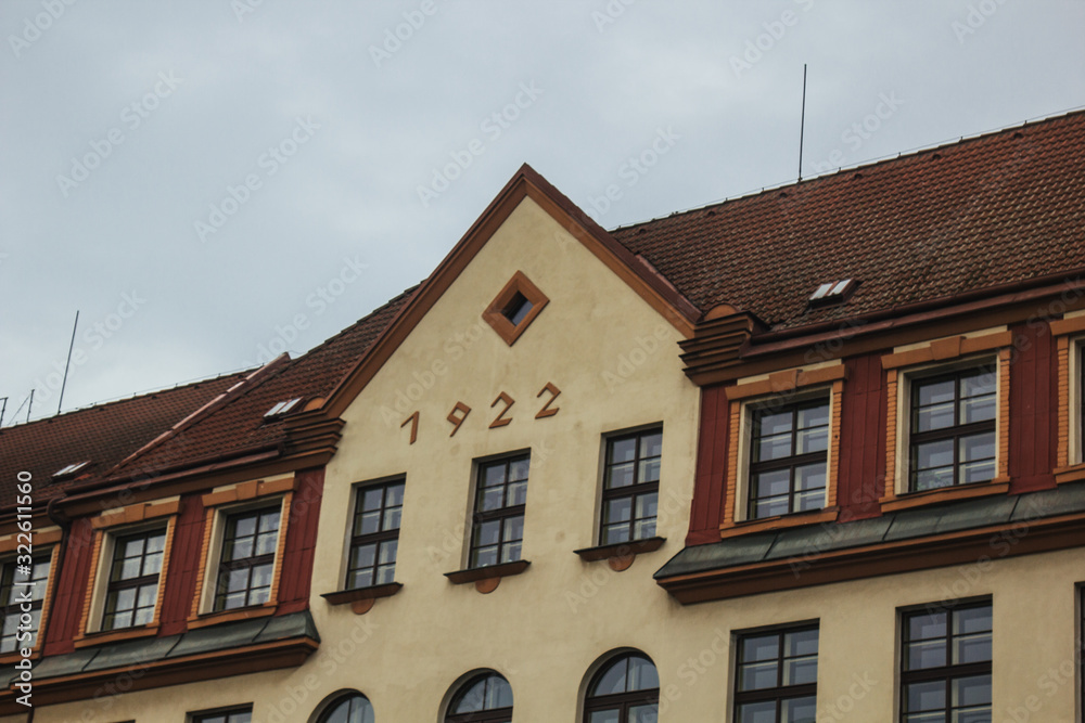 Fototapeta premium Prague, Czech Republic. 10.05.2019: Close-up view of the facade with windows of old historical buildings in Prague. Retro, old-fashioned, vintage, last century.