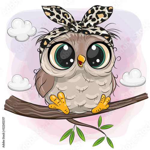 Owl with big eyes is sitting on a branch