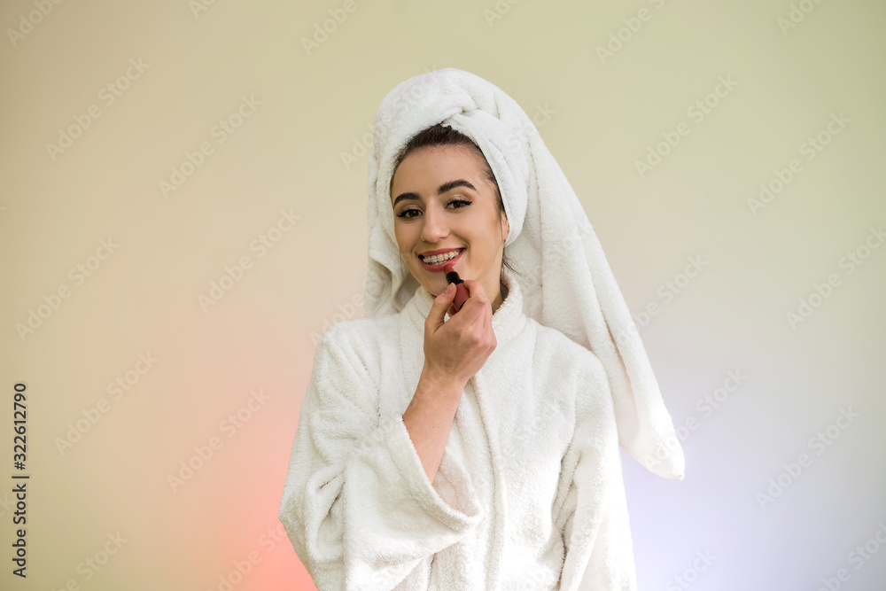 Young beautiful woman doing itself makeover  isolated on green