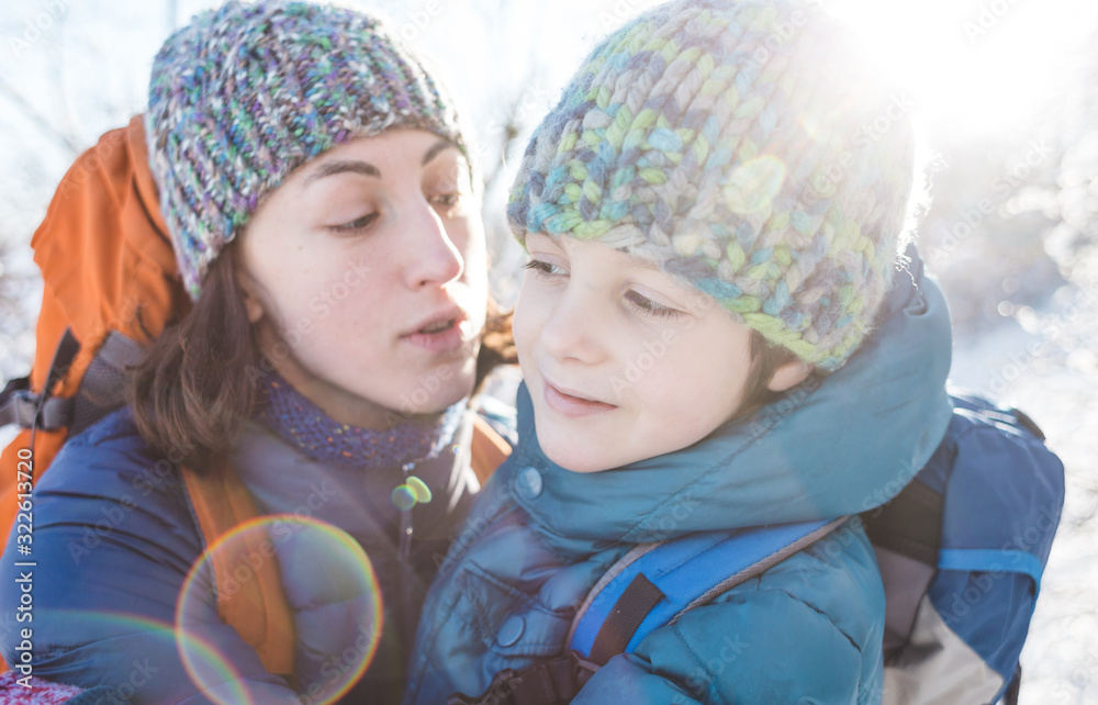 Obraz premium Mom kisses and hugs her son.