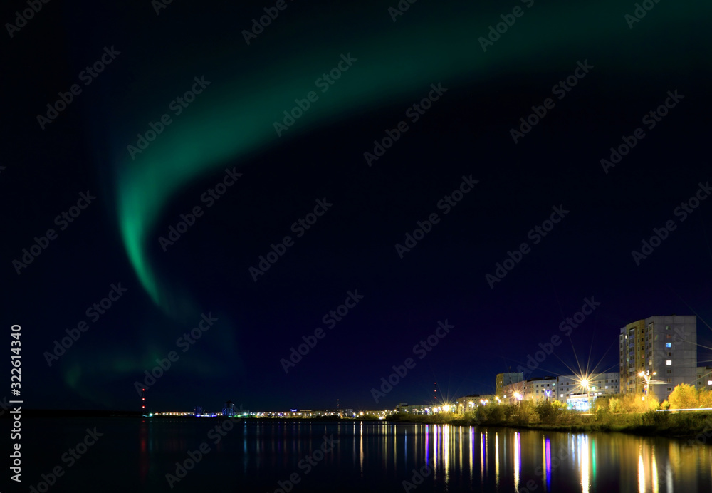 Night Siberian city of Nadym and the Northern lights above it