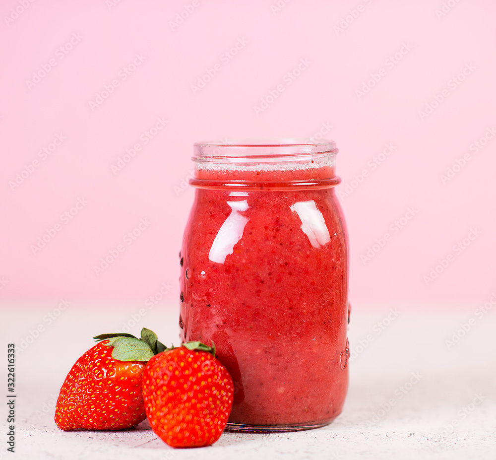 Red berry smoothie in a glass jar on a pink background. Selective focus. Red berry smoothie in a glass jar on a pink background. Selective focus.
