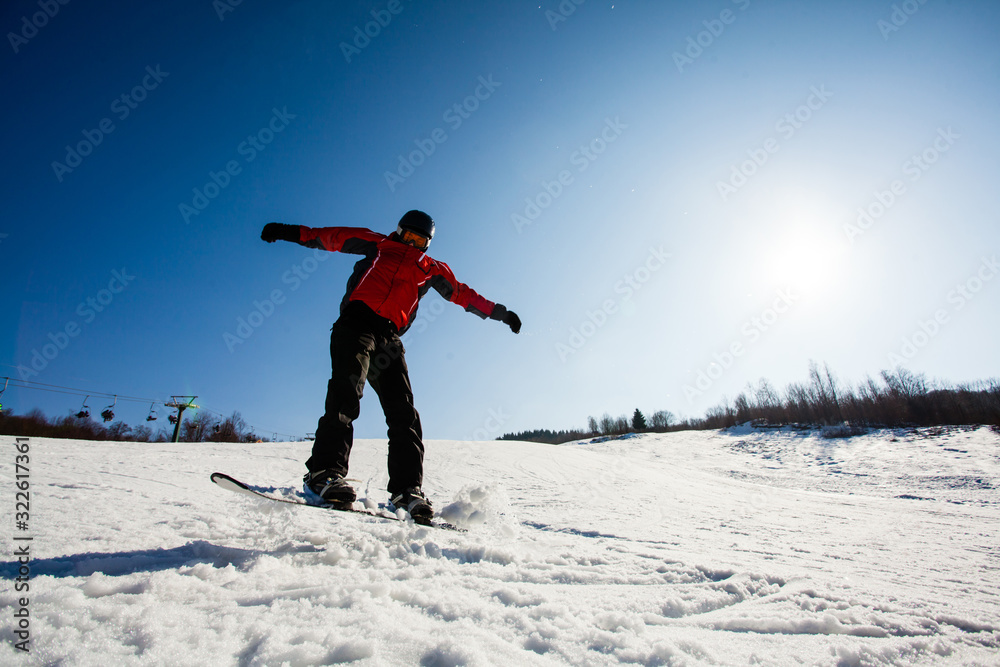 Professional snowboarder riding down the snow slope