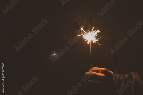 sparkler on black background in hand