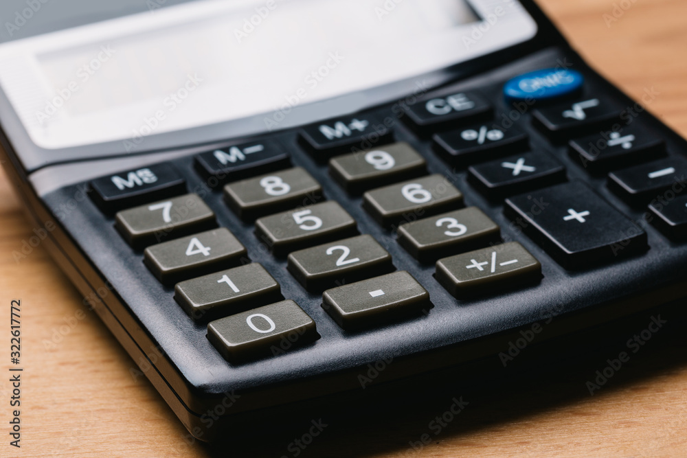 Modern calculator, Business and Finance accounting concept on wooden table Modern calculator, Business and Finance accounting concept on wooden table