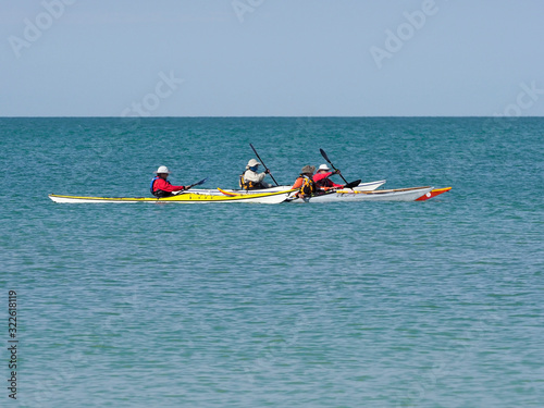 Obraz na plátně Group of kayakers paddling across a calm Gulf of Mexico at St