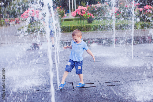 Little boy trying to stop the flow of water