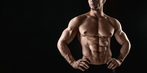 Unrecognizable Strong Athletic Sexy Muscular Man on Black Background.