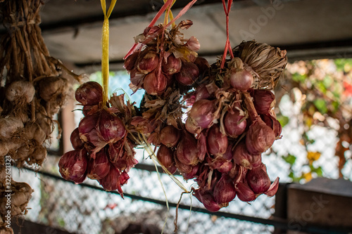 Shallots are hanging together in cubes.