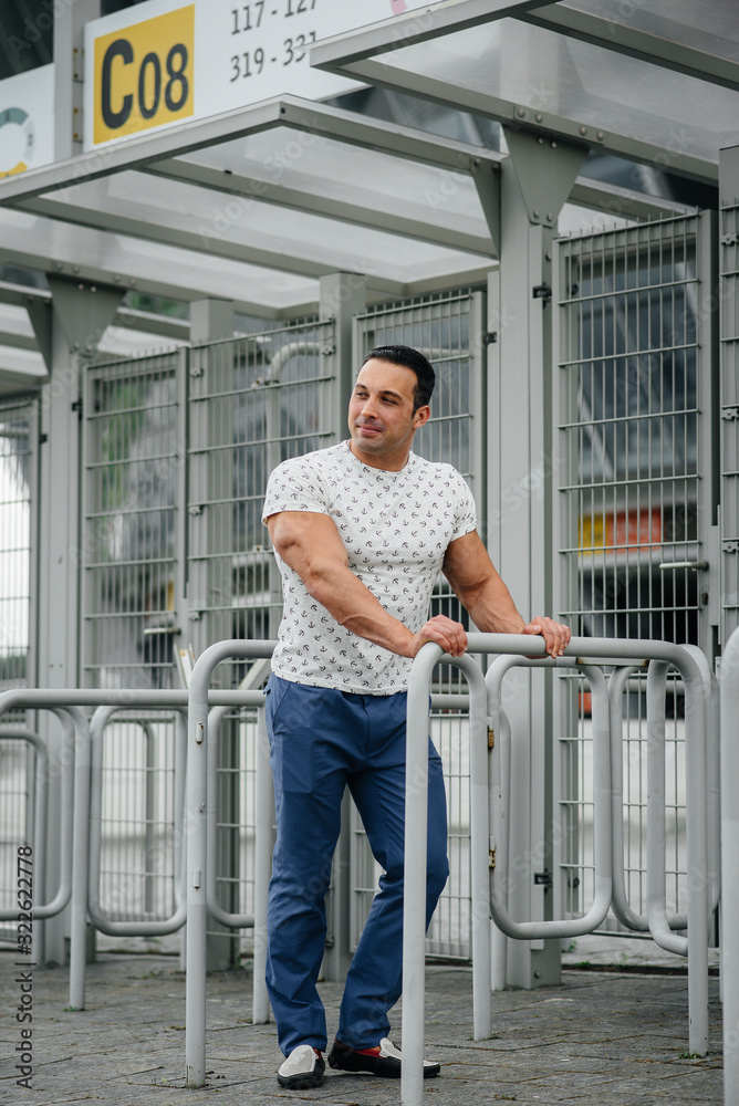 A sports guy stands and enjoys a walk near the stadium. Lifestyle A sports guy stands and enjoys a walk near the stadium. Lifestyle