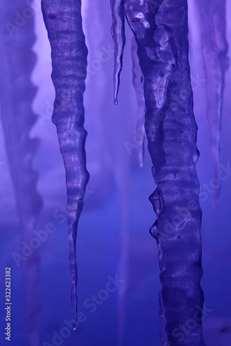VERTICAL: Detailed shot of a long icicle inside an ice grotto in Colorado.