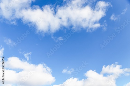 Blue sky background. Blue sky with fluffy white clouds. Copy space