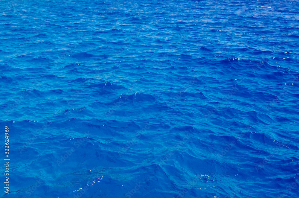 Obraz premium a piece of beautiful red sea close-up. The deep blue color of the sea. Background from sea water