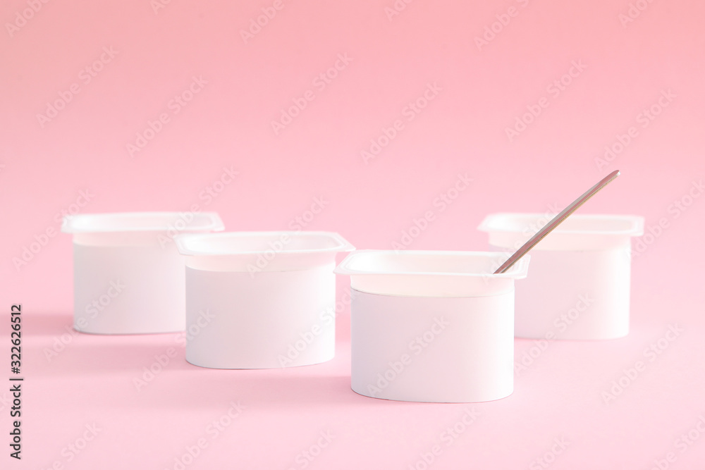 Tasty yogurt in a plastic glass on a colored table. Place to insert text. Useful snack. Tasty yogurt in a plastic glass on a colored table. Place to insert text. Useful snack.