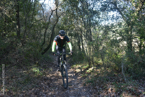 Mountain biker through a forest