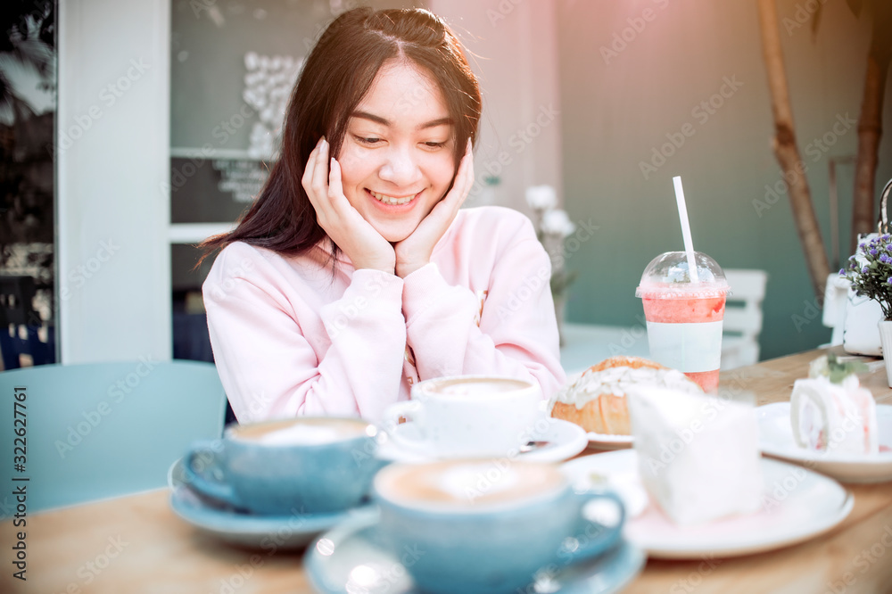 Asian woman Happy With eating snacks And her drink Asian woman Happy With eating snacks And her drink
