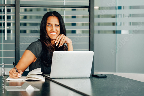 Woman taking notes on conference call