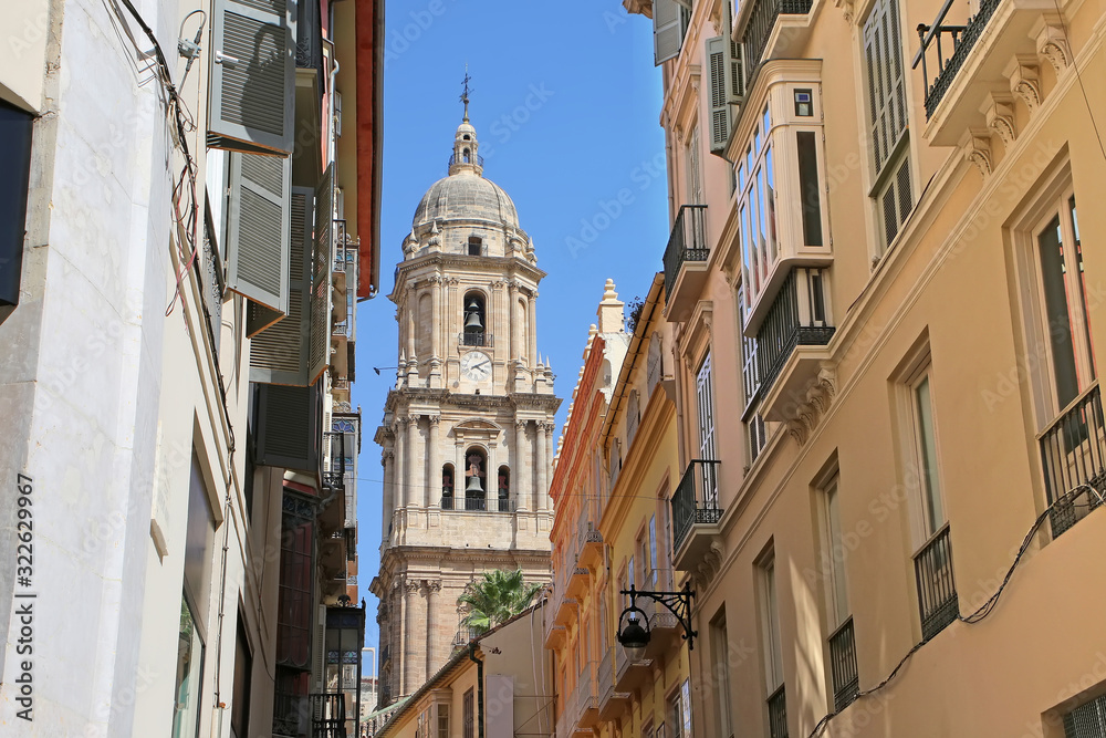 Looking towards the Cathedral through the city narrow streets, in the downtown, Malaga,  Andalusia, Southern Spain.