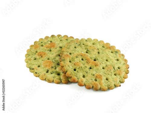 Round crispy cracker with herbs, two pieces closeup isolated on white background side view
