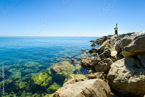 Guide lighthouse at the breakwater of Cabopino Beach in Marbella