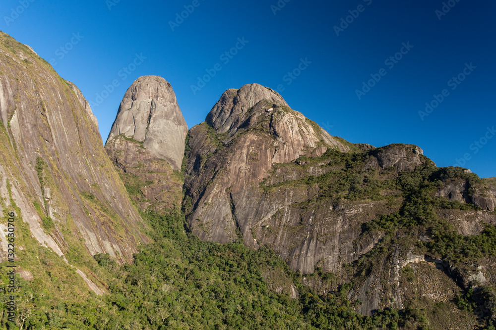 Beautiful view to dramatic rocky mountain peaks over green rainforest Beautiful view to dramatic rocky mountain peaks over green rainforest