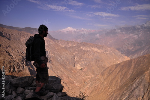 Adventurous man observing the mountainous landscape