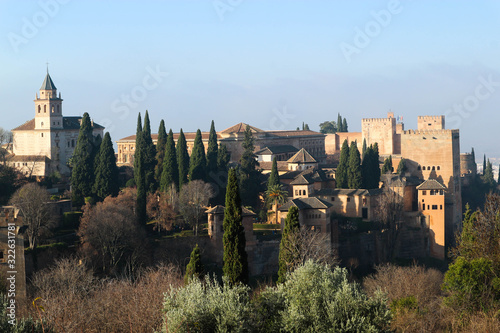 Panoramic view of the Alhambra citadel and palaces from Generalife gardens in foggy winter morning