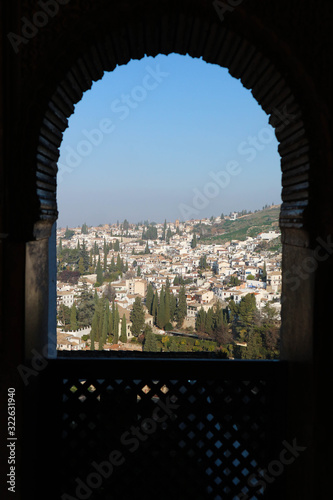 Wallpaper Mural View to Granada city through the openwork arched window of Generalife palace, Alhambra, Granada, Spain Torontodigital.ca