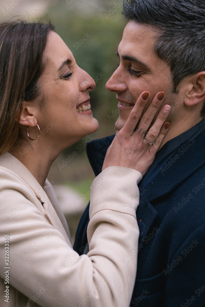 Young couple kissing with complicity Young couple kissing with complicity
