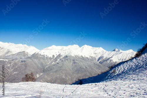 Beautiful view of the snowy mountain peak in the Alps. Wonderful sunny weather. Sochi
