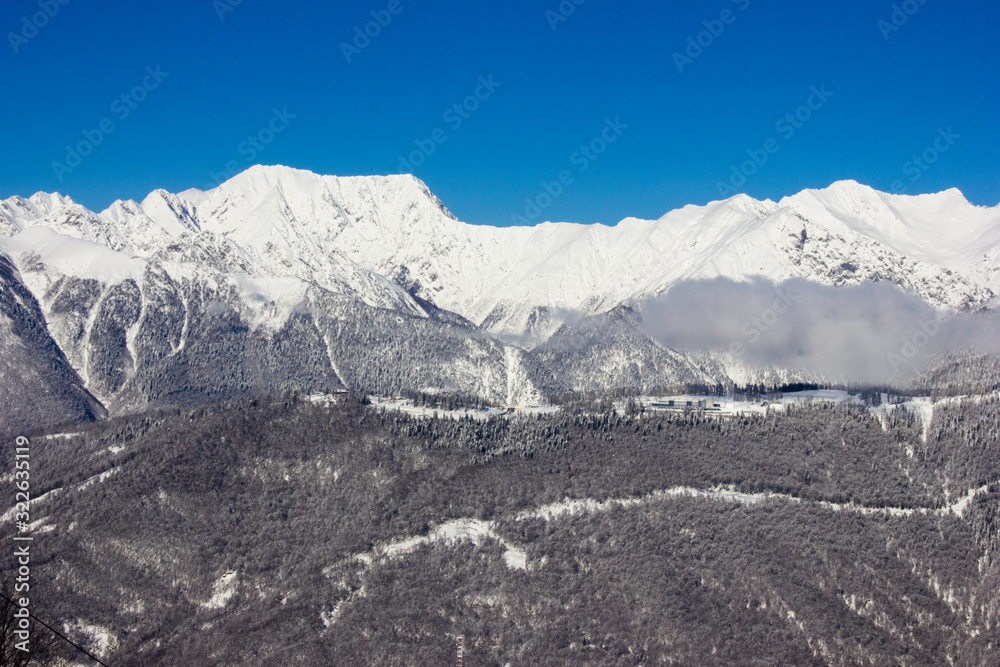 Beautiful view of the snowy mountain peak in the Alps. Wonderful sunny weather. Sochi