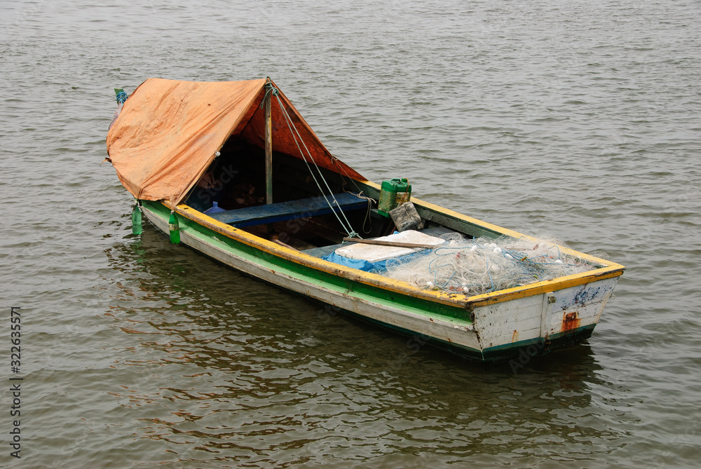 hing boats anchored in the river, floating peacefully in harbor.